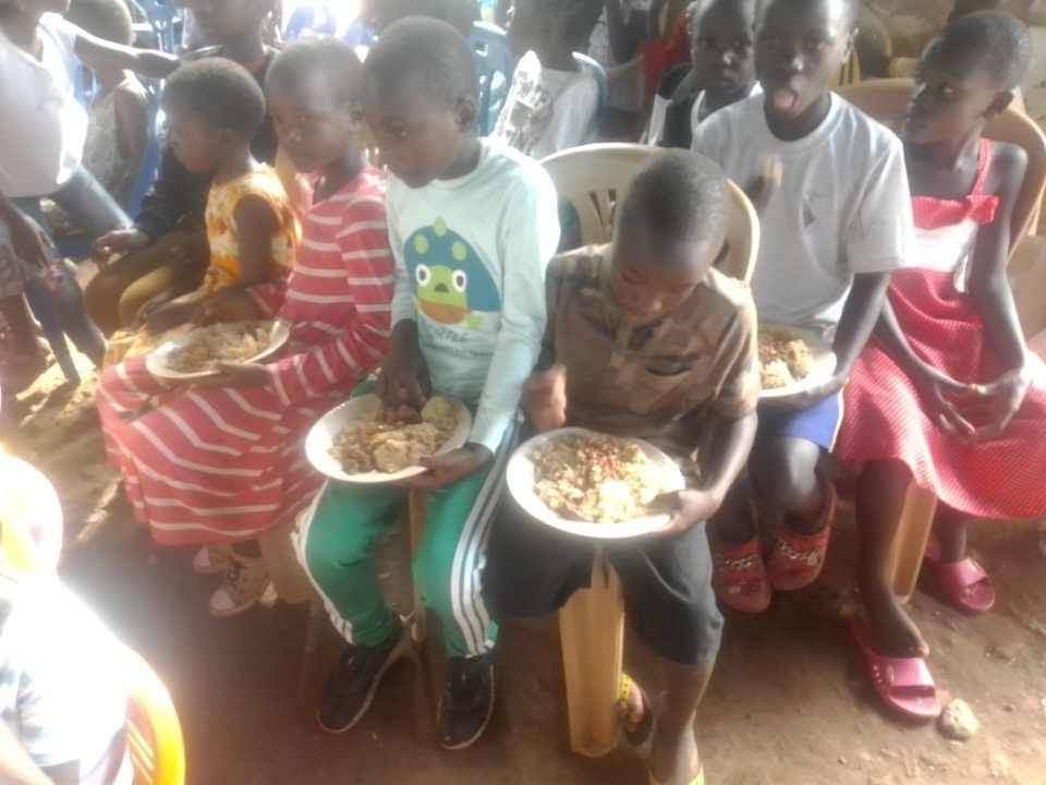 Children being served a meal at The Mountain Church in Uganda