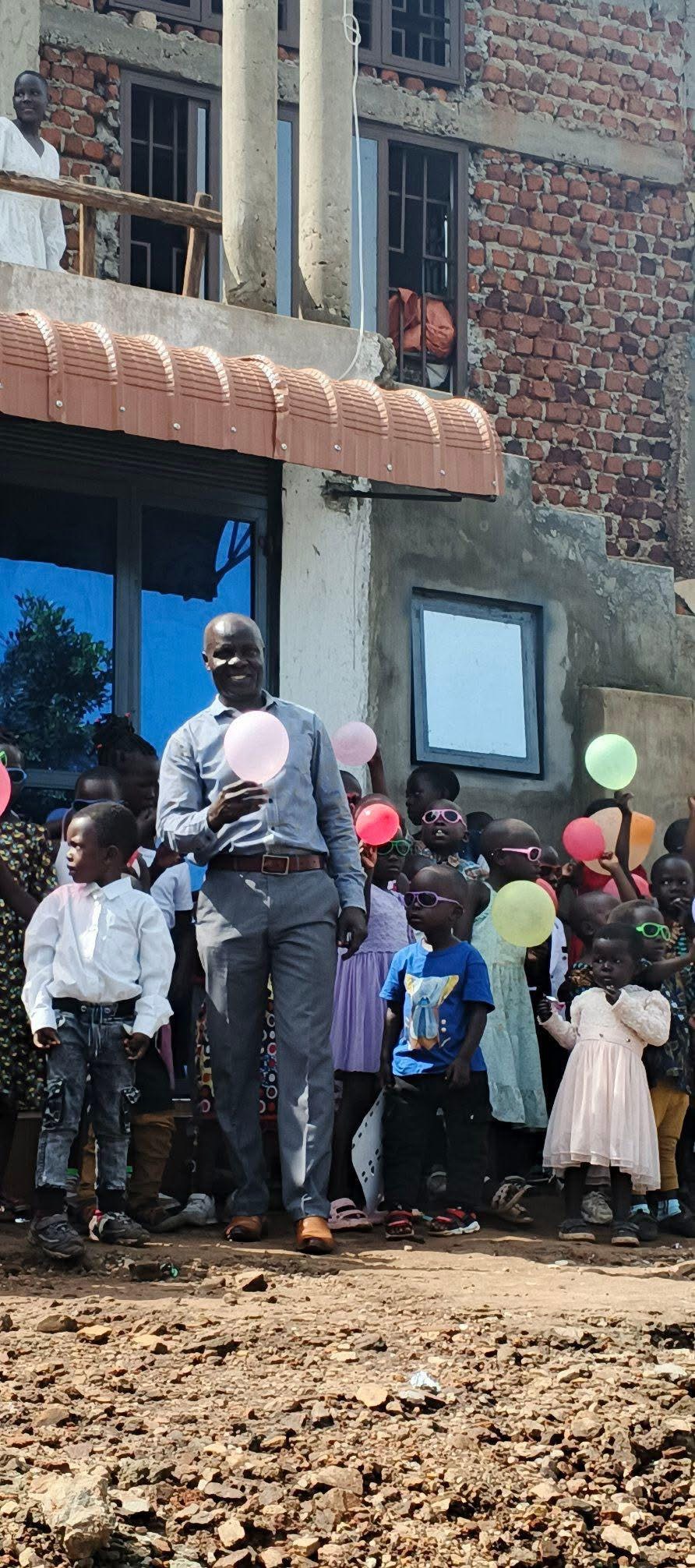 A celebration with balloons outside The Mountain Church building in Uganda